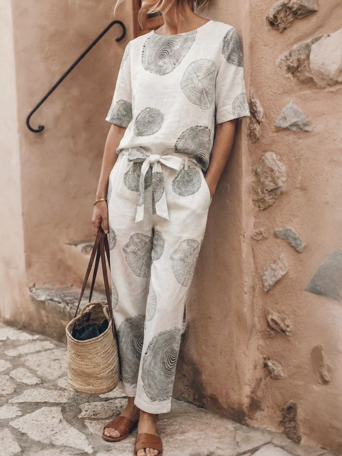 Woman wearing relaxed cotton-linen set with short-sleeve top and straight-leg pants in monochrome tone