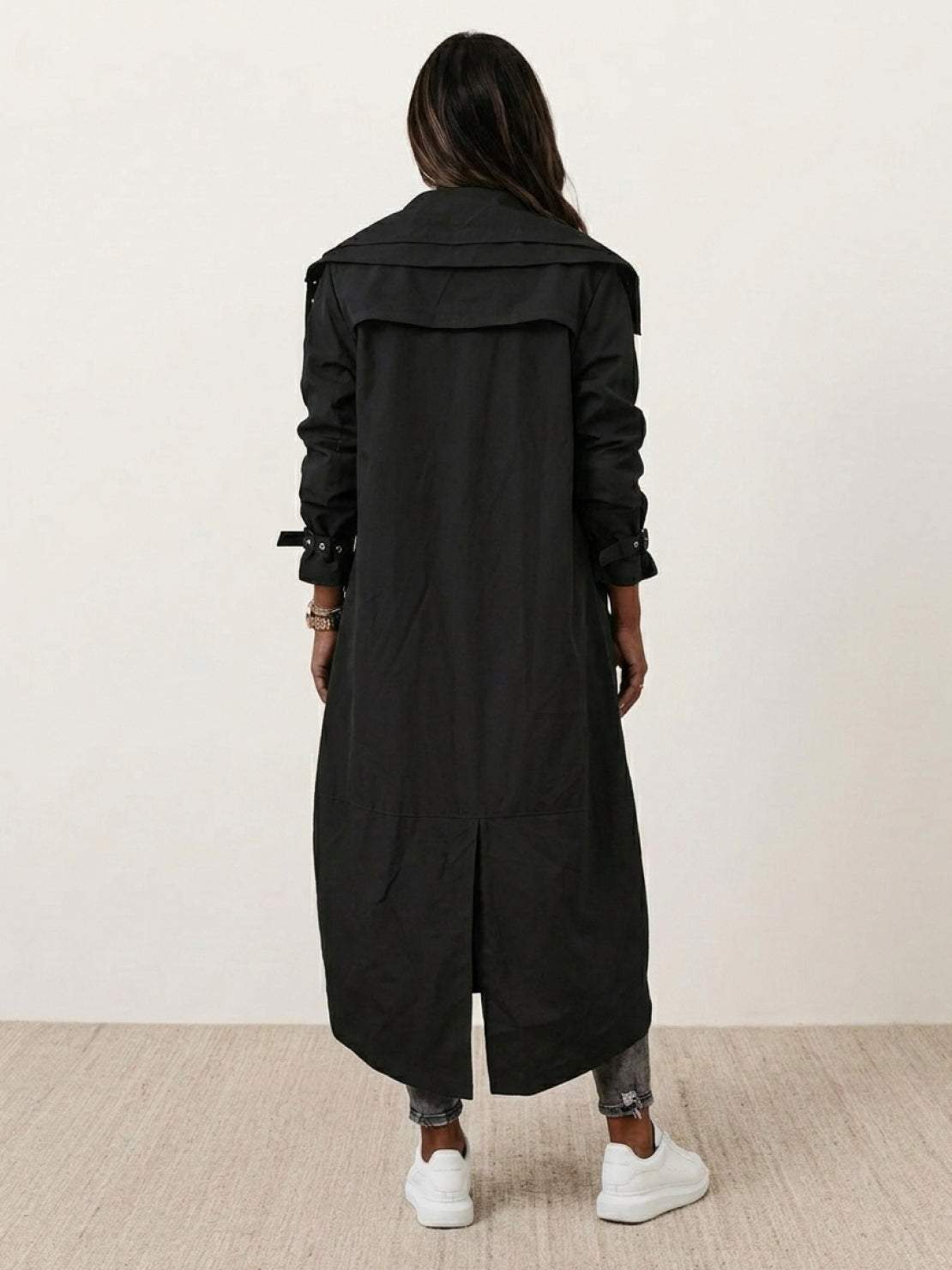 woman wearing sleek minimalist hooded coat outdoors