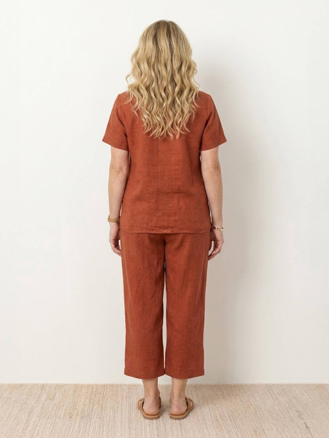 Woman wearing a breezy cotton blend two-piece set with short sleeves and elastic waist pants outdoors