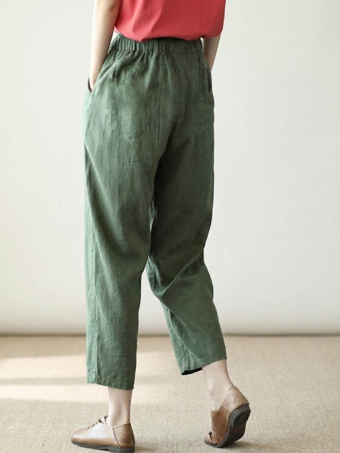 Woman wearing black breezy relaxed fit straight pants standing in a bright room