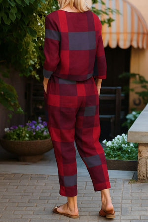woman wearing cotton-linen monochrome red and black checkered relaxed longline top and fluid wide-leg pants outfit back view