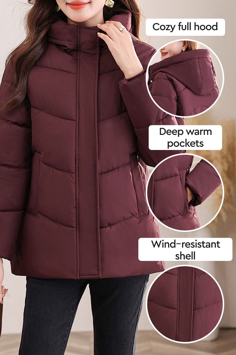 Everyday Warmth Coat mid-length hooded jacket with 5-layer thermal insulation, wind-resistant shell, deep warm pockets, and cozy full hood in dark burgundy.