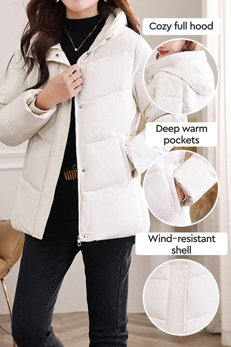 Woman wearing Everyday Warmth Coat with cozy hood, deep pockets, and wind-resistant shell in light color