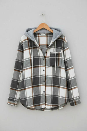 Highland Plaid Shacket with soft fleece lining, attached hood, button-front, and front pocket in gray and white plaid pattern.
