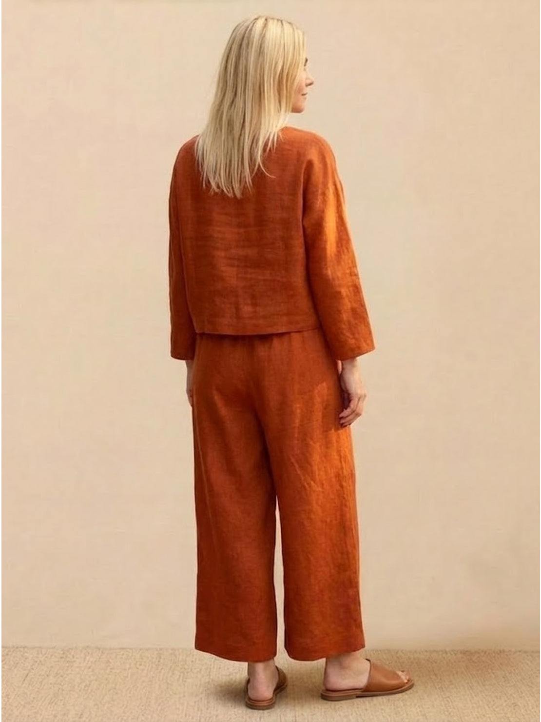 woman wearing loose solid color two-piece set with wide-leg pants and pullover top