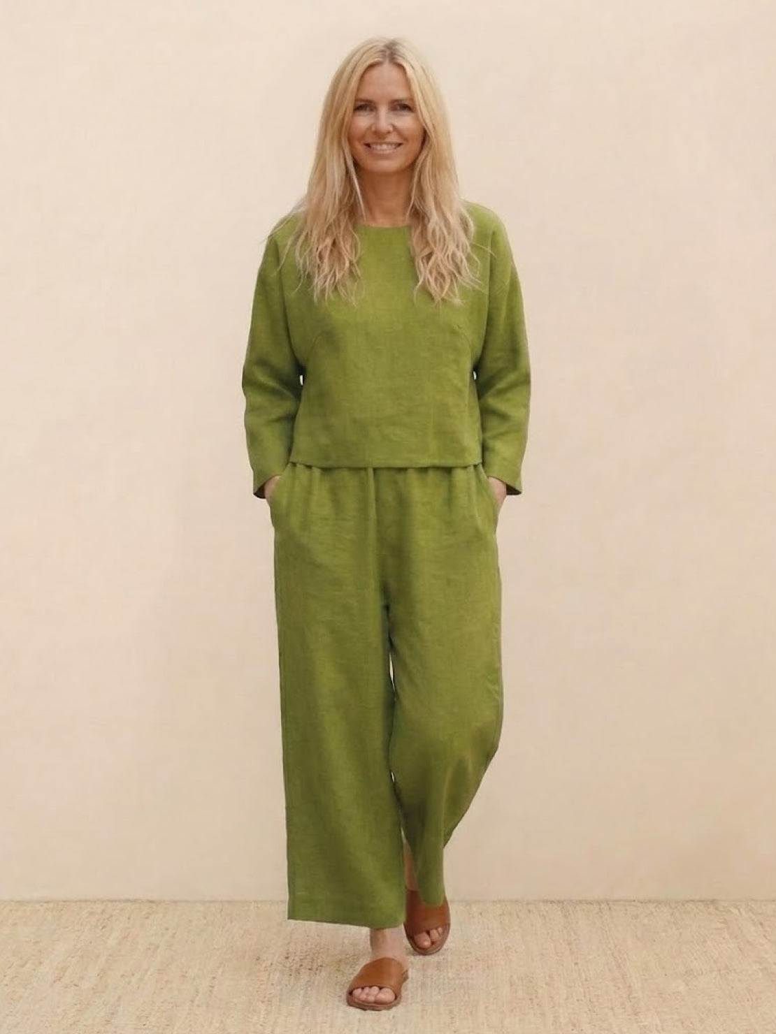 woman wearing loose solid color two-piece set with wide-leg pants and round-neck top