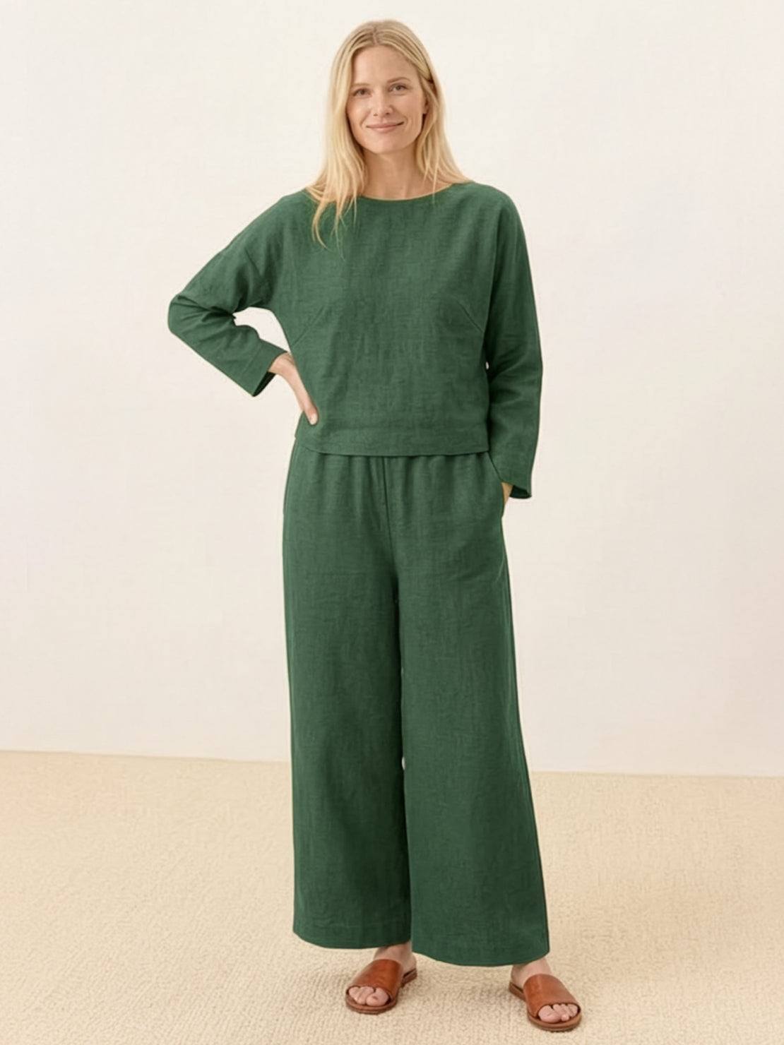 woman wearing loose solid color two-piece set with round-neck top and wide-leg pants outdoors