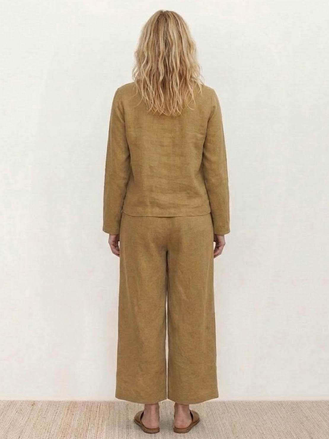 woman wearing loose solid color two-piece set with wide-leg pants and pullover top