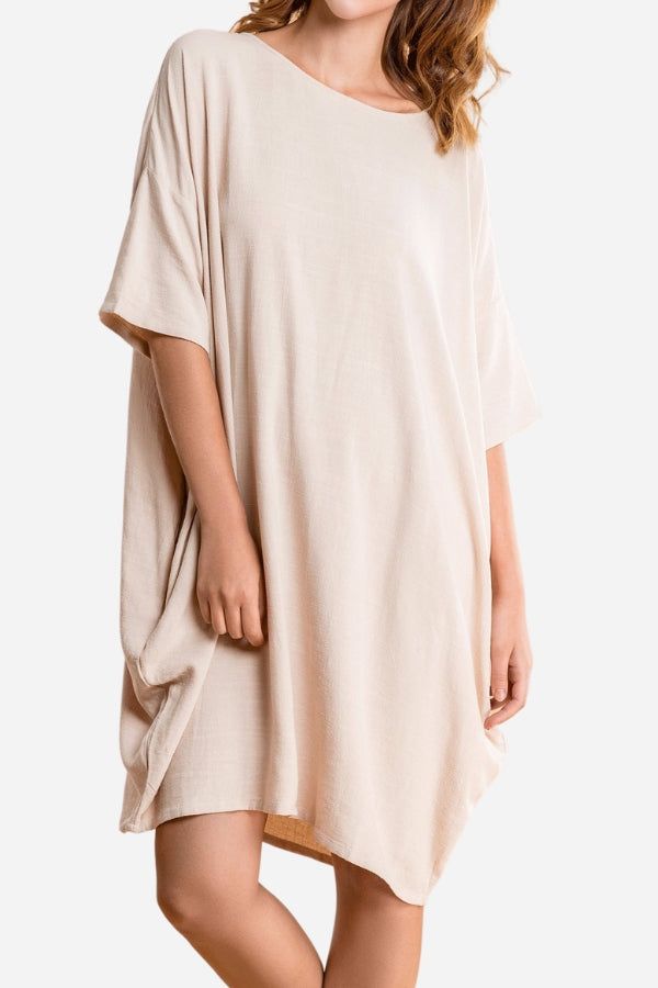Nude oversized premium linen dress with short sleeves and pockets, loose fit, soft breathable fabric.