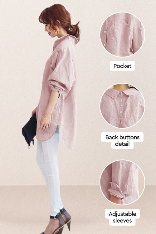 Woman wearing oversized linen shirt in sun-washed pink with back button detail and adjustable sleeves