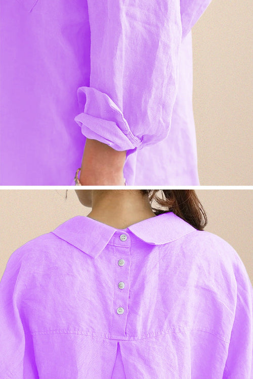 Close-up of oversized linen shirt in soft purple showing rolled-up sleeve and back button detailing