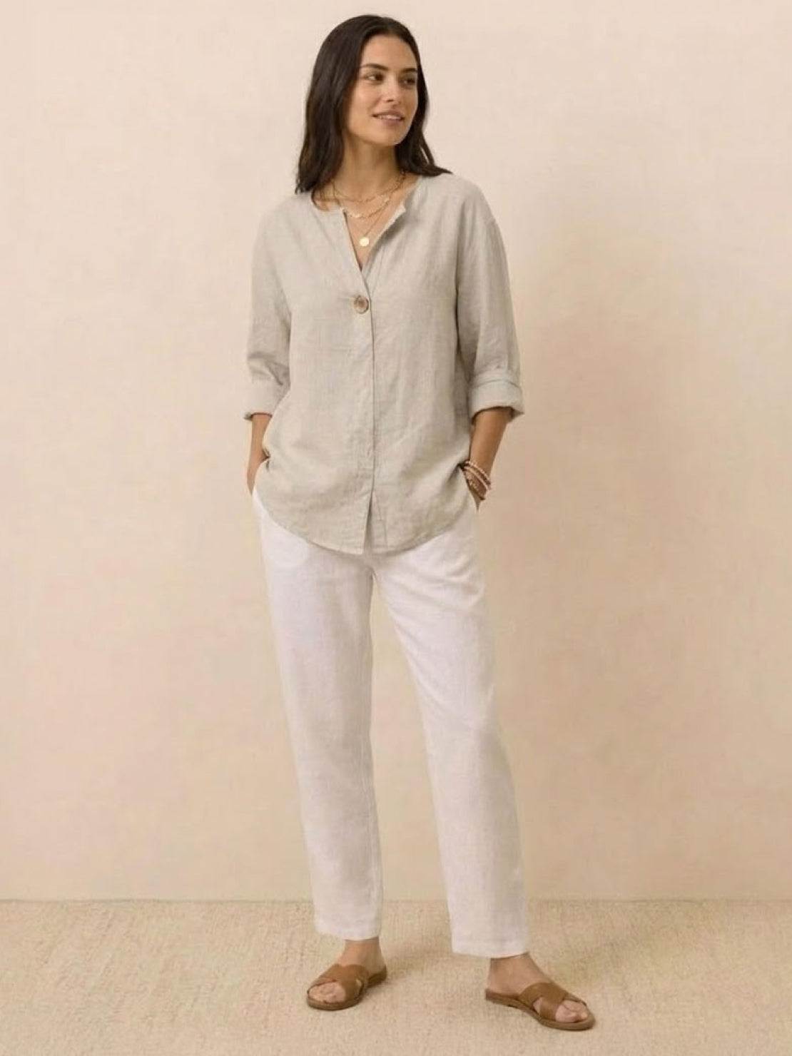 Woman wearing a pure linen age-defying shirt with button details, soft breathable fabric perfect for warm weather.