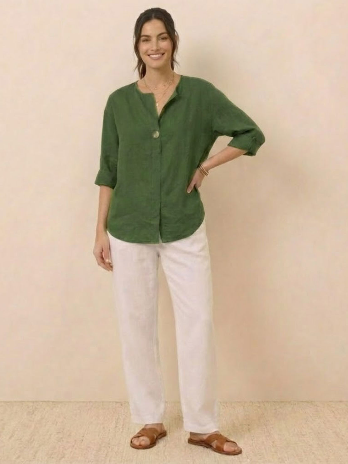 White pure linen age-defying shirt with button detail displayed on hanger