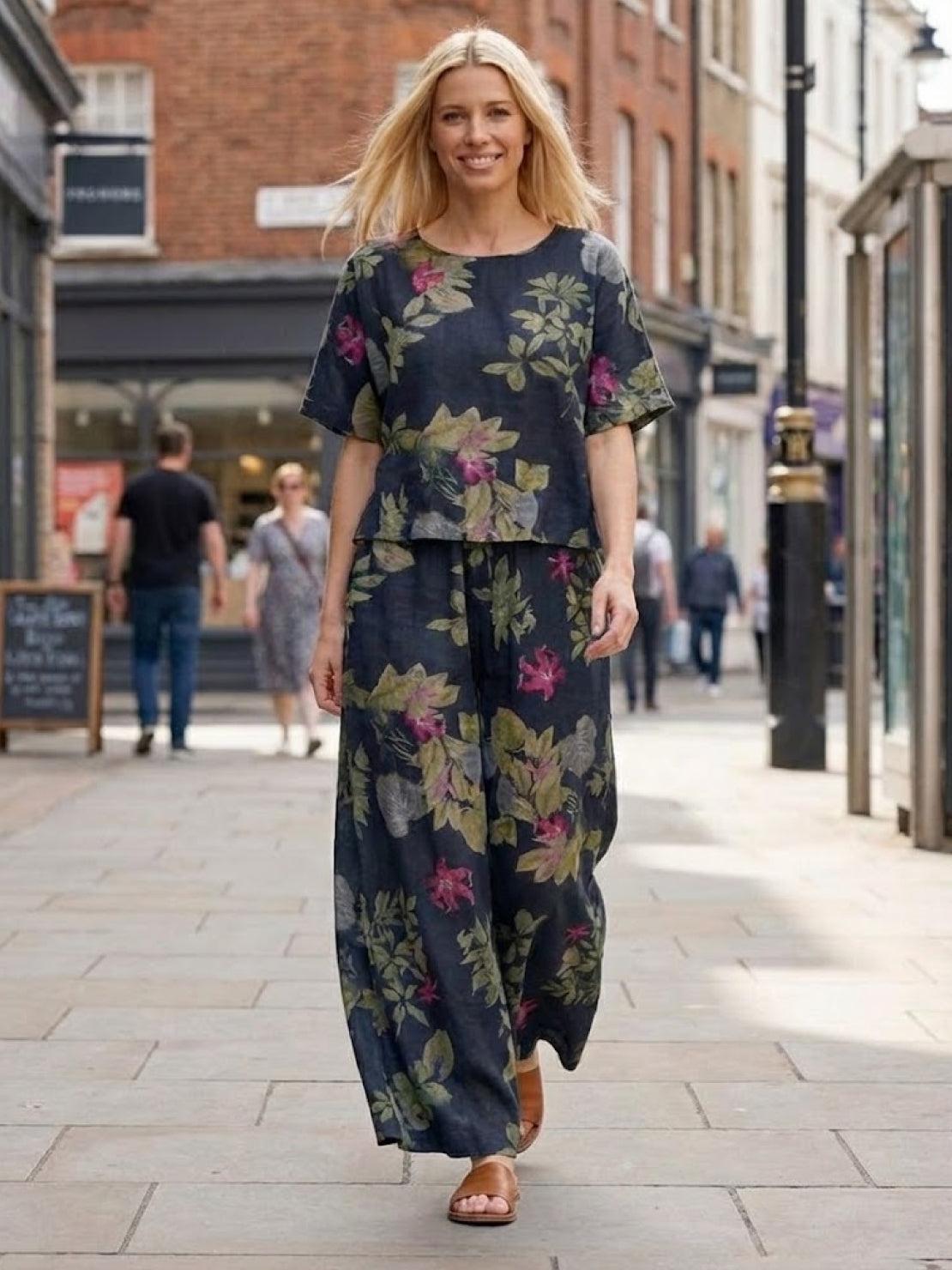 Woman wearing floral print loose fit co-ord set with wide-leg bottoms walking outdoors