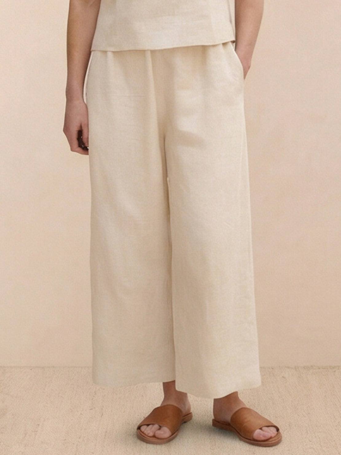 Woman wearing a loose fit co-ord set with soft-tailored top and wide-leg bottoms in a relaxed two-piece outfit