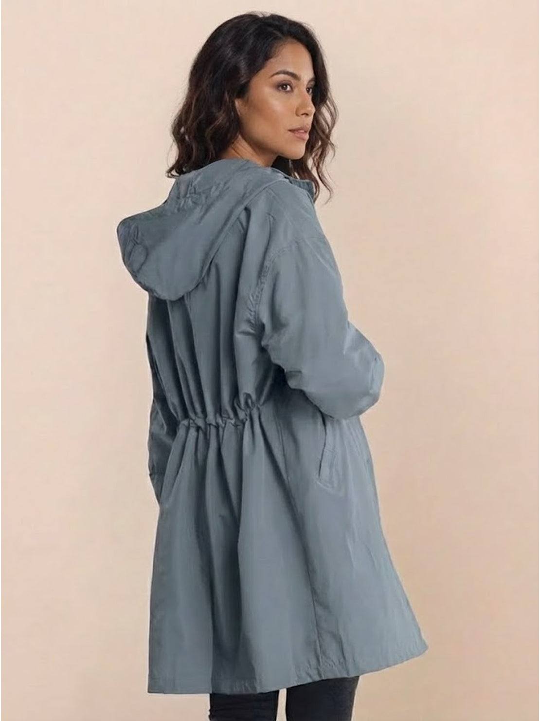 Woman wearing gray oversized Rain Couture Windbreaker jacket with hood, back view