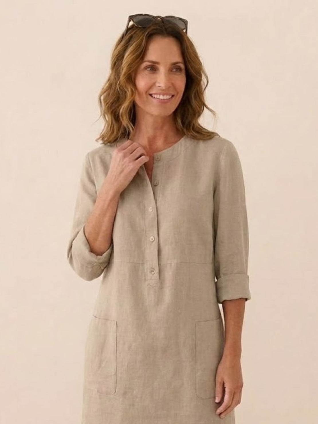 Woman wearing timeless class cotton dress in khaki with rolled 3/4 sleeves and front buttons