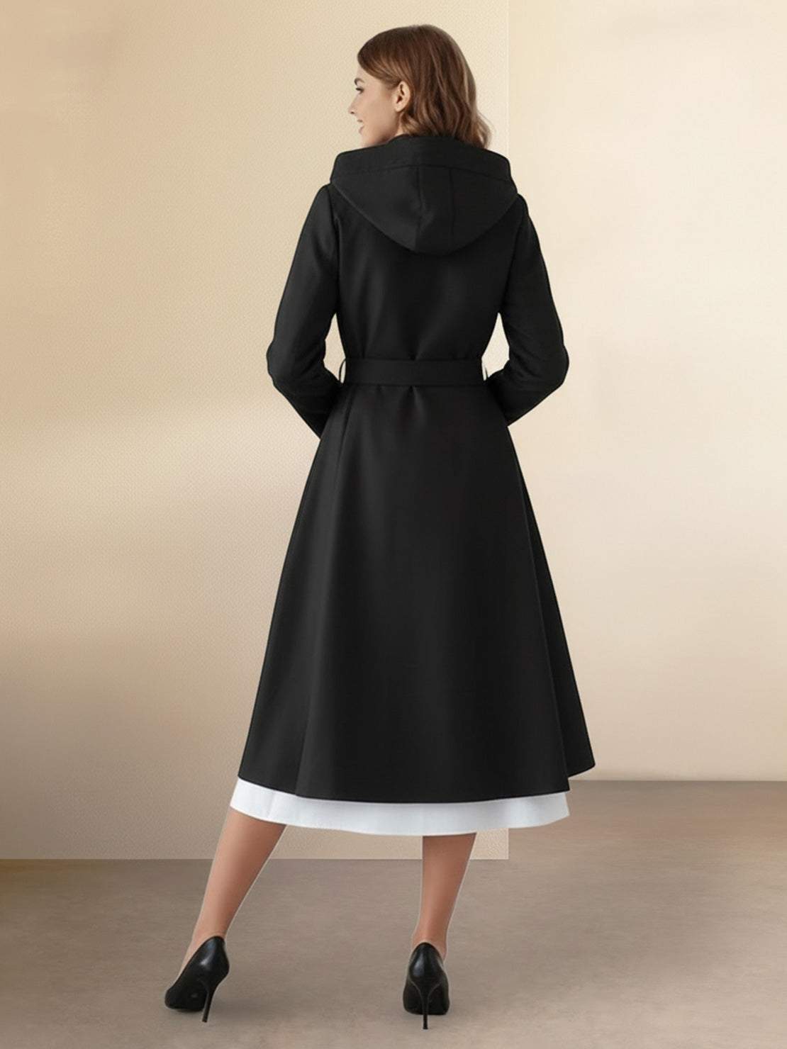 Woman wearing water-repellent A-line hooded raincoat with belt outdoors