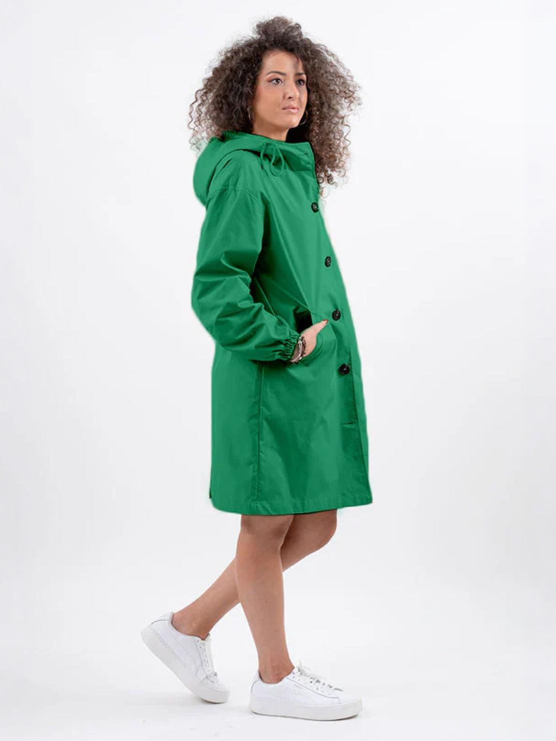 Water-resistant oversized hooded windbreaker rain jacket on outdoor model