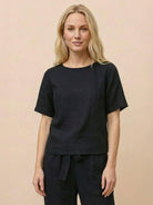 Woman wearing relaxed monochrome cotton linen set with short-sleeve top and straight-leg pants