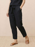 Woman wearing relaxed fit cotton linen set with short-sleeve top and straight-leg pants in monochrome tones