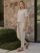 Woman wearing breathable cotton linen set with relaxed short-sleeve top and straight-leg pants in monochrome tones