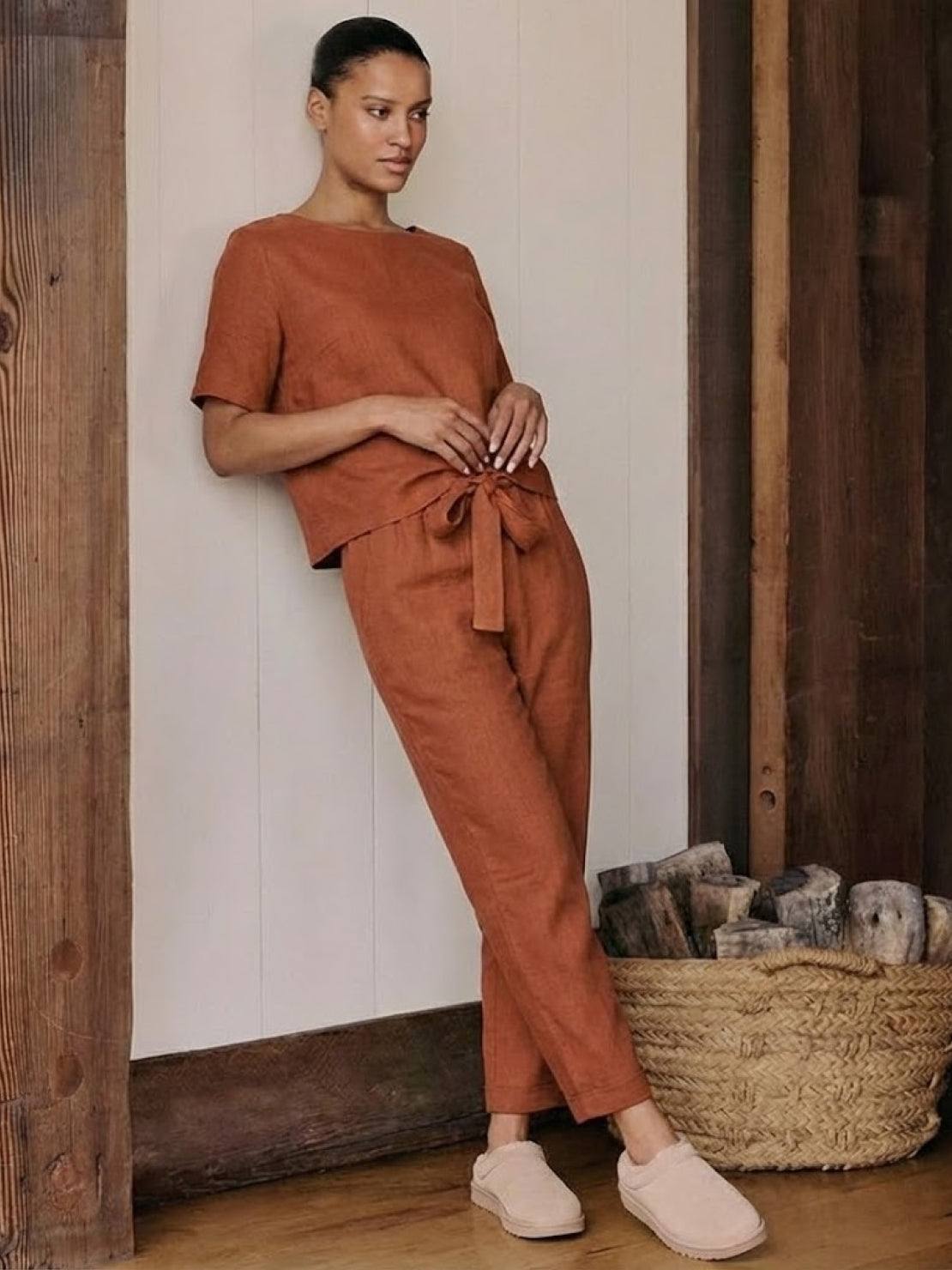 Woman wearing relaxed 100% cotton linen set with short-sleeve top and straight-leg pants in monochrome tones