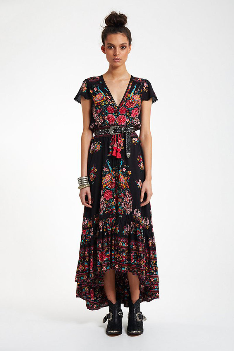 Black Peacock Gypsy Dress with floral and peacock prints, short sleeves, V-neckline, mid-calf length, styled with belt and boots
