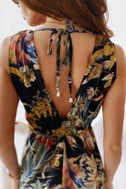 Back view of casual sleeveless print strap dress with floral pattern and tie detail