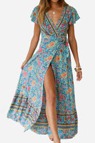 Bohemian floral print wrap dress with V-neck and high slit in vibrant blue and multicolor floral pattern