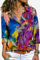 Women wearing a colorful long-sleeved casual printed loose shirt with abstract floral design and white pants