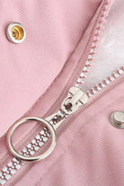 Close-up of pink thick long-sleeve zipper overcoat with silver ring zipper pull and snap button detail