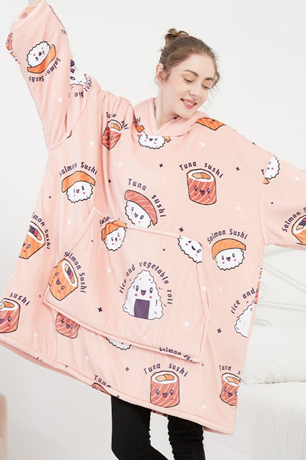 Woman wearing snuggly oversized hooded fleece sweater with pink sushi cartoon print