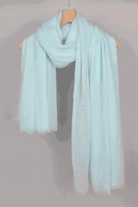 Light blue Linen Color-POP Scarf hanging on wooden hanger, breathable and warm eco-linen fabric.