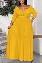 Plus size yellow dress with deep V-neck, tie belt, and 3/4 sleeves in soft fabric