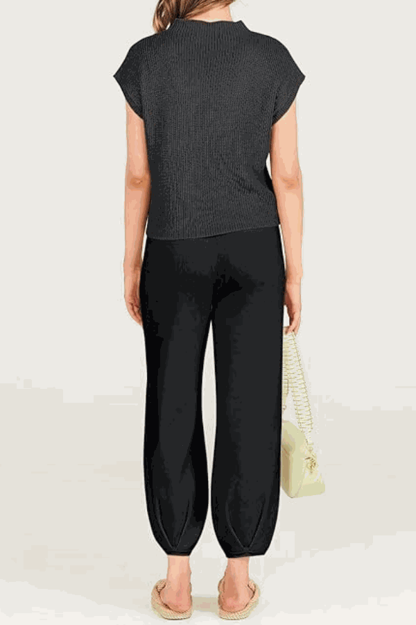 Woman wearing black Comfy Couture Knit Sweater two-piece set with short sleeves and high-waisted pants viewed from the back