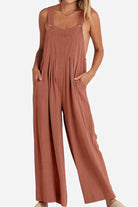 Woman wearing rust-colored Free-Flow Wide Leg Overalls made of breathable cotton blend fabric