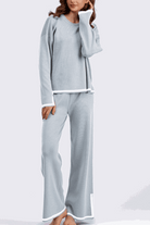 Long sleeved relaxed fit lounge two-piece set in light blue with white trim, featuring a loose sweater and wide-leg palazzo pants.