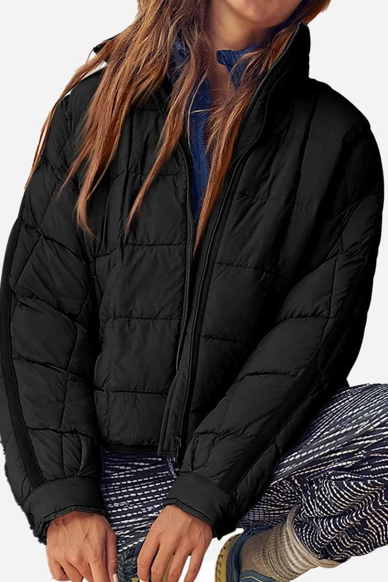 black lightweight puffer travel jacket with full zip and quilted design for women