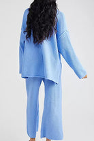 Woman wearing light blue oversized two-piece set for multi-weather comfort with relaxed fit and wide pants