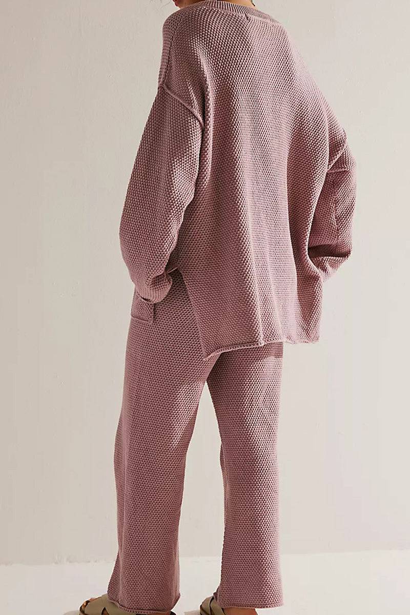 Back view of woman wearing dusty pink textured two-piece oversized set for multi-weather comfort