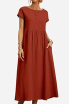 Women’s capped-sleeve voluminous pleated midi dress in rust with a stomach-flattening drape and pockets.