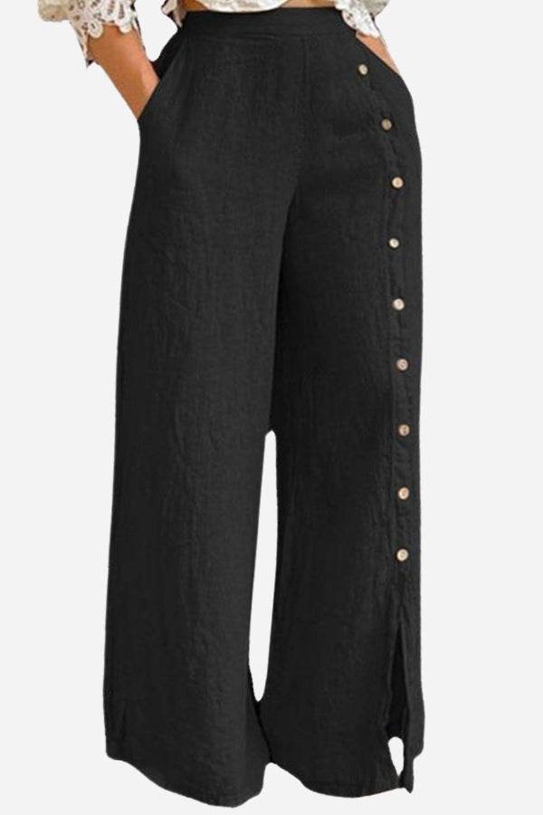 Black wide leg pants with side button detail and high waist, made from breathable cotton blend.