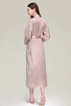 Back view of woman wearing blush pink Mulberry Silk Nightgown with sash belt and long sleeves