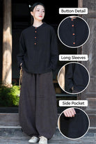 Black ramie linen and cotton blouse with long sleeves, button detail, and side pocket, styled with loose pants for a relaxed fit