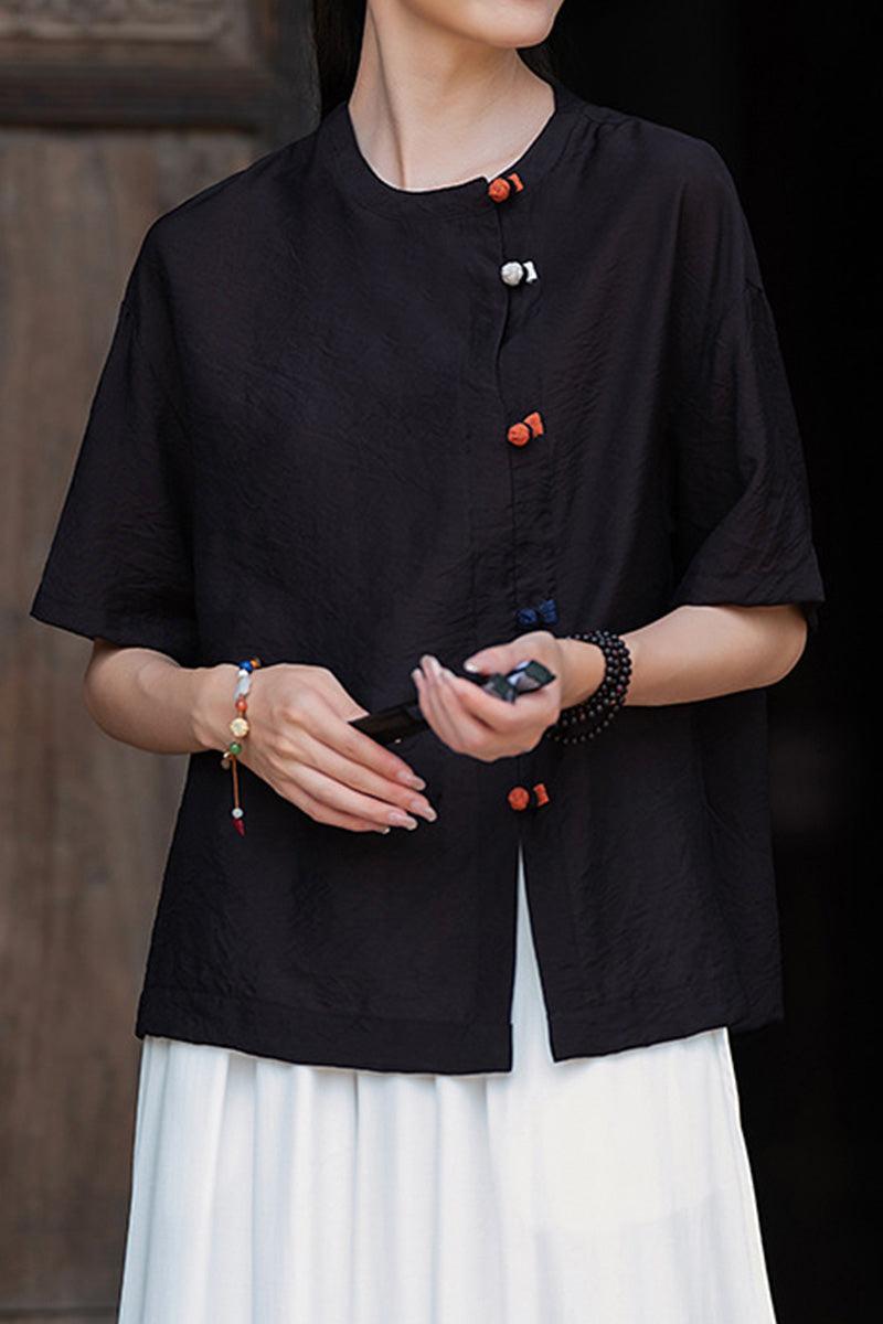 Black regenerated cellulose blouse with asymmetrical buttons and relaxed fit on model