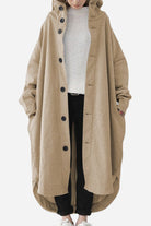 Oversized beige buttoned hooded coat worn over casual outfit, lightweight and roomy fit.