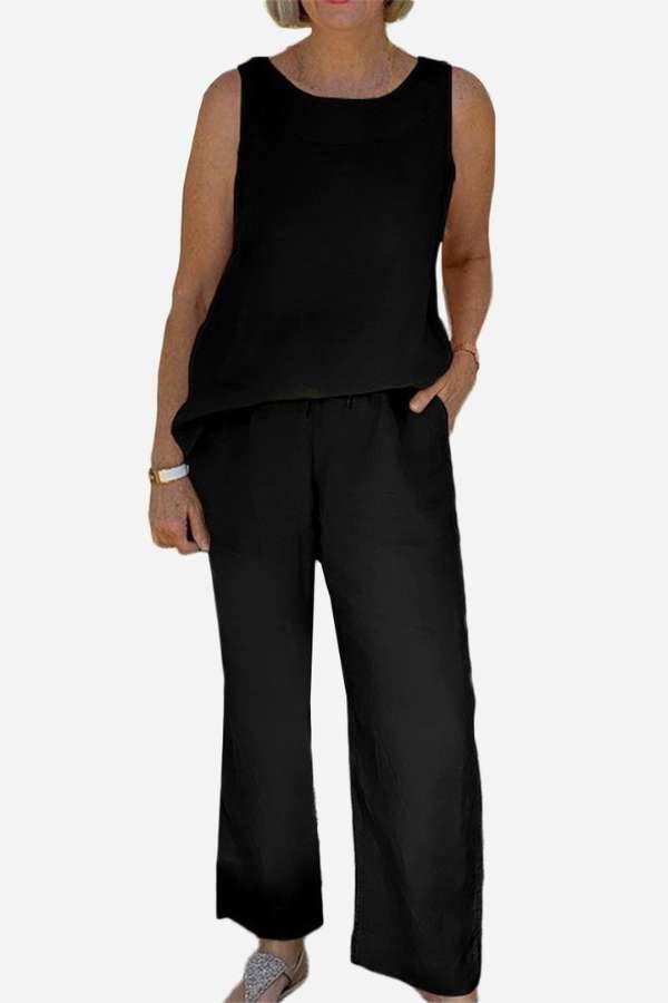 Woman wearing a black sleeveless sleek silhouette coordinated set with wide-leg pants and a relaxed fit top.