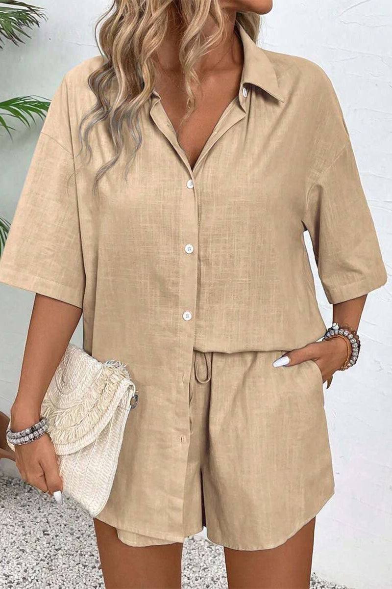 Beige Coastal Linen Cotton two-piece set with button-up top and shorts worn by woman holding woven clutch.