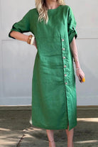 green pure cotton elegance dress with side buttons and three-quarter sleeves on woman